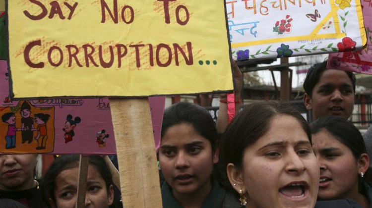School students shout slogans during a protest against a corruption case in Jammu February 12, 2011. Indian Prime Minister Manmohan Singh faces more political headaches after the Supreme Court pressed for deeper probes into a multi-billion dollar corruption case and a ruling coalition ally was implicated in the scandal. Allegations the government may have lost up to $39 billion in revenues after firms were awarded telecoms deals at rock-bottom prices in return for kickbacks have rocked the ruling coalition and compounded the fragility of India's fragile investment climate. REUTERS/Mukesh Gupta (INDIAN-ADMINISTERED KASHMIR - Tags: CIVIL UNREST POLITICS BUSINESS CRIME LAW)